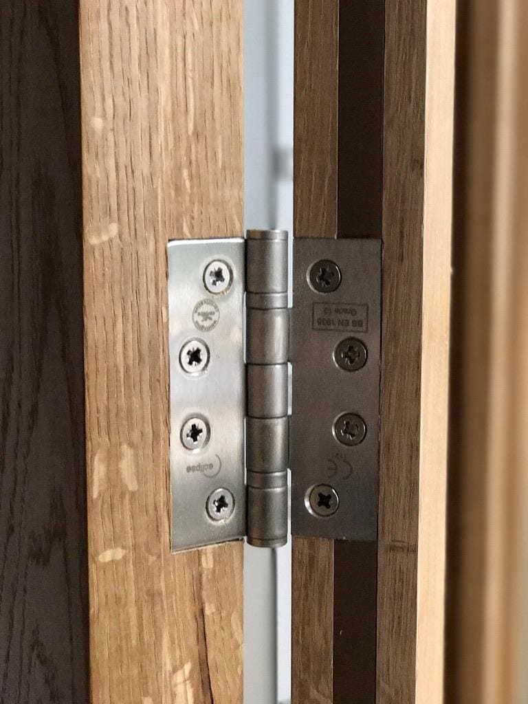 Heavy duty hinge detail on a bespoke oak door