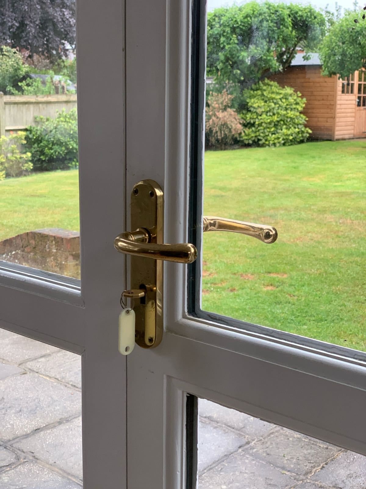Brass handle and lock detail on glazed timber doors