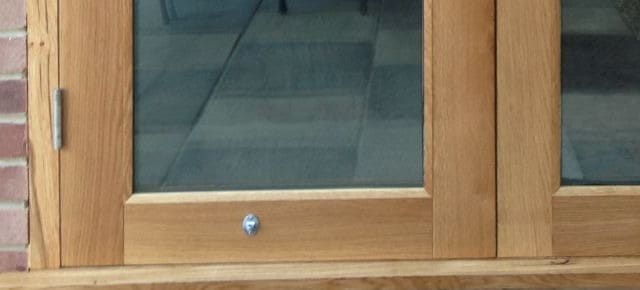 Oak sill and bottom rails of a pair of French doors