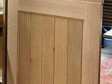 Vertical oak boarding within a solid oak door frame