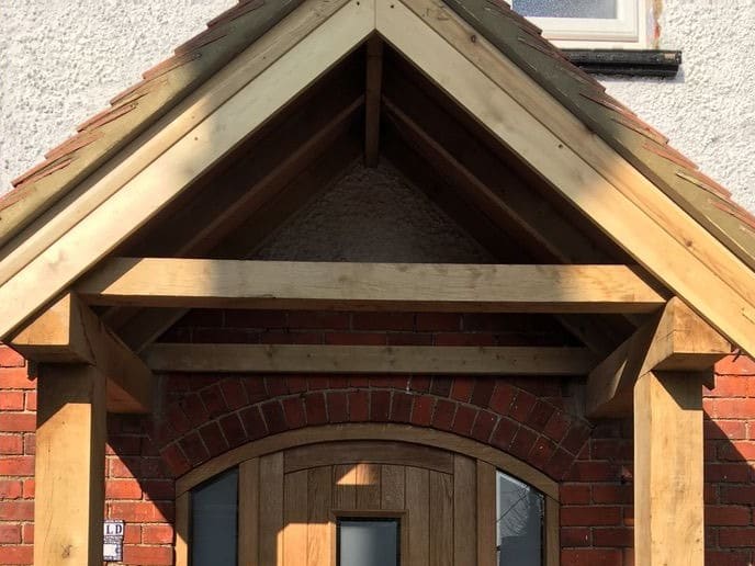 Oak porch frame with jointed posts, beams and brackets