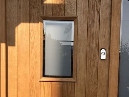 Glazed vision panel set into a boarded oak front door