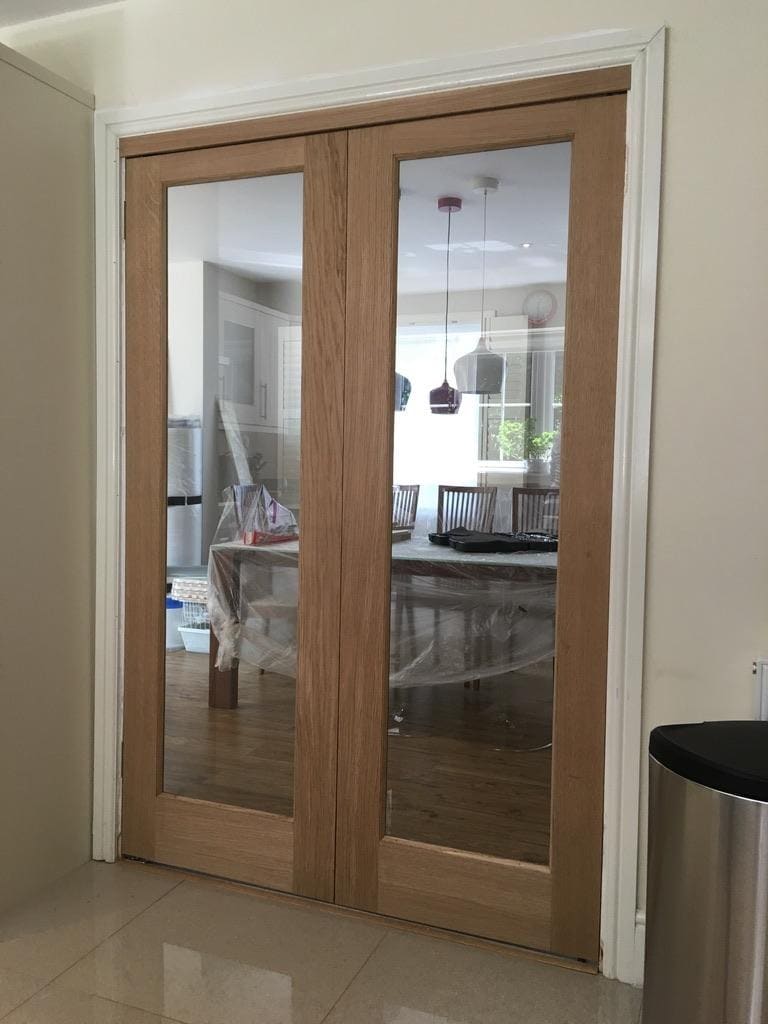 Pair of glazed internal oak doors opening into a dining room