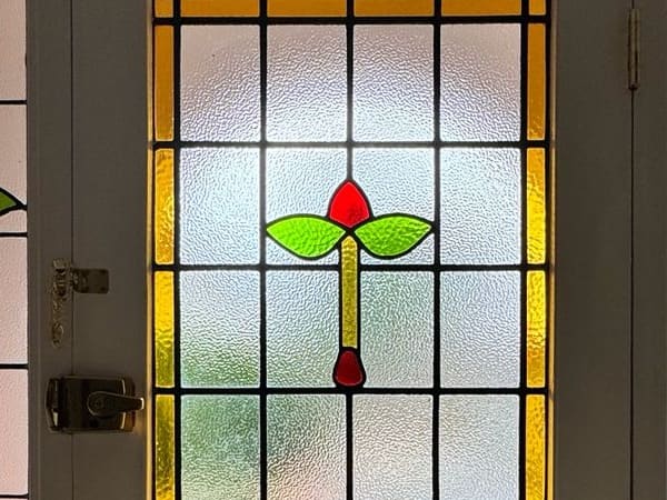 Leaded stained glass panel with a tulip motif in a period front door