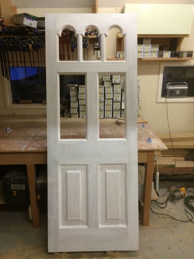 Four-panel door with arched glazing bars, in primer