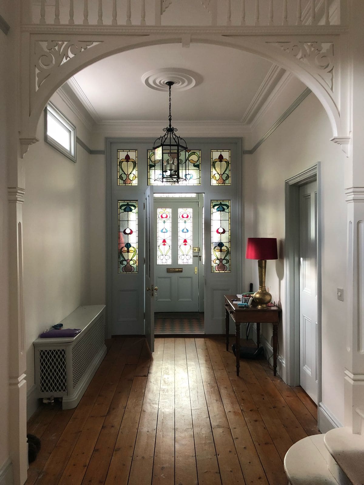 Stained glass entrance screen and inner door in a period hall