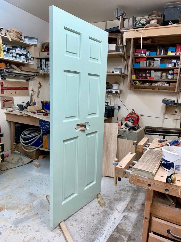 Six-panel door finished in the workshop before fitting