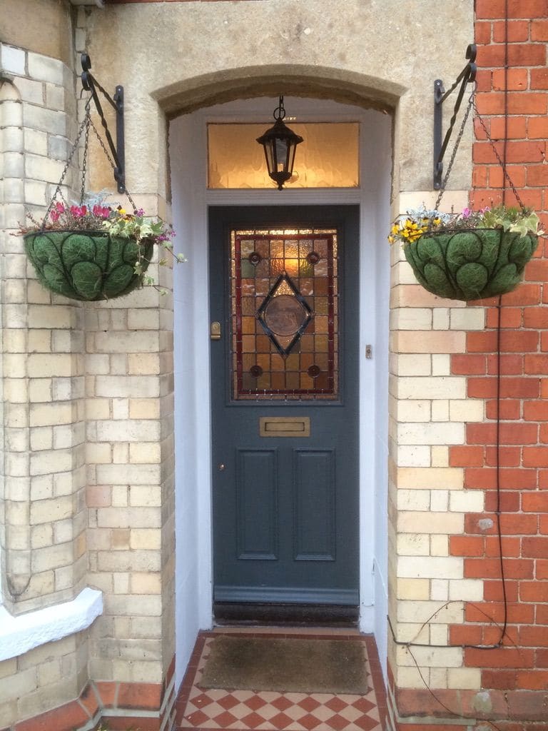 Victorian four-panel door with a stained glass upper panel