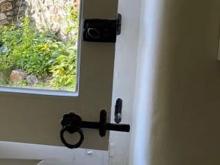 Black ring latch and bolt on the inside of a painted stable door